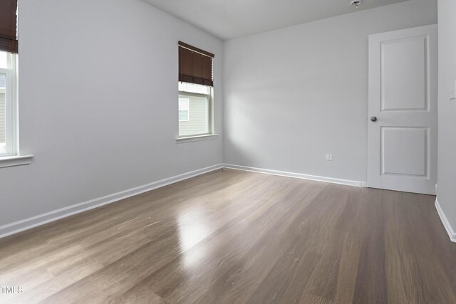 1021 Benay Rd, Morrisville, NC 27560 - empty room featuring wood finished floors, baseboards, and a pendent fire sprinkler