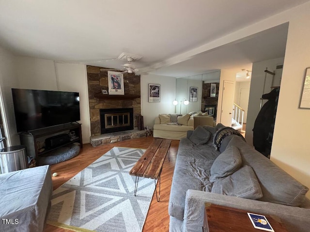 1708 Quail Ridge Rd, Raleigh, NC 27609 - living area with a stone fireplace, ceiling fan, and wood finished floors