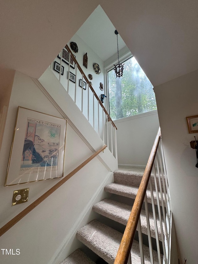 1708 Quail Ridge Rd, Raleigh, NC 27609 - stairway featuring a chandelier and baseboards