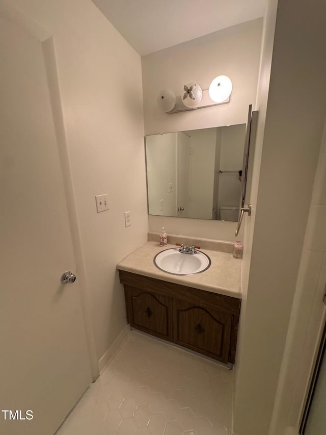 1708 Quail Ridge Rd, Raleigh, NC 27609 - bathroom featuring tile patterned floors, vanity, and baseboards