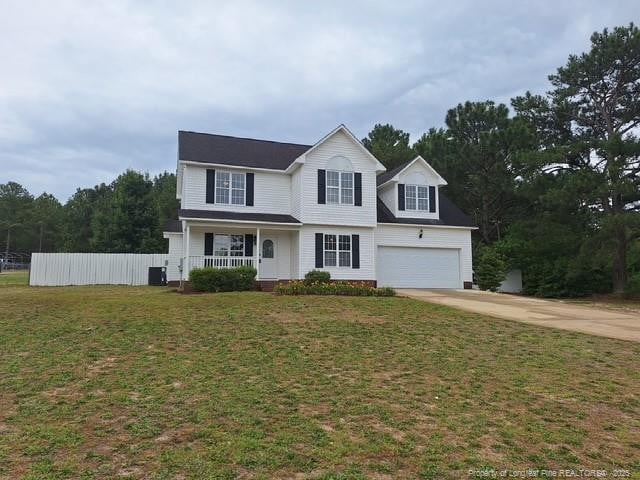 19 Ribbon Oak Ct, Sanford, NC 27332 - traditional home with covered porch, concrete driveway, a front yard, and cooling unit