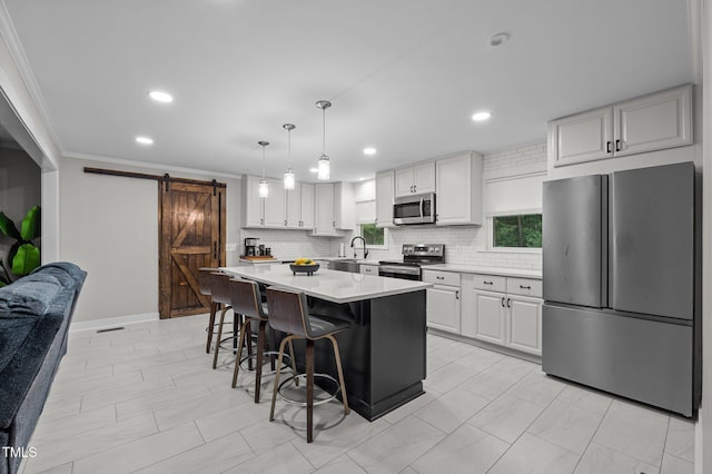 1785 Mitchells Chapel Rd, Pittsboro, NC 27312 - kitchen with appliances with stainless steel finishes, a barn door, light countertops, a kitchen breakfast bar, and backsplash