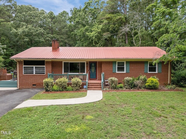1785 Mitchells Chapel Rd, Pittsboro, NC 27312 - ranch-style home featuring crawl space, brick siding, covered porch, metal roof, and a front lawn