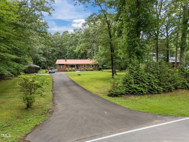 1785 Mitchells Chapel Rd, Pittsboro, NC 27312 - single story home featuring asphalt driveway, a front yard, and a wooded view