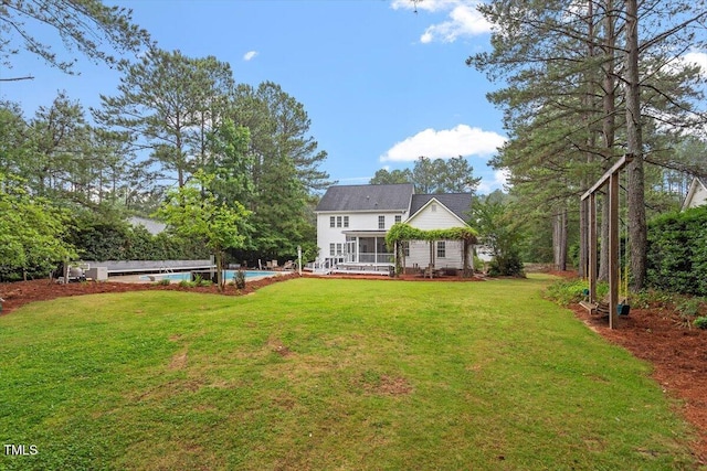1817 Foxbrook Dr, Raleigh, NC 27603 - rear view of property with an outdoor pool, a lawn, and a deck
