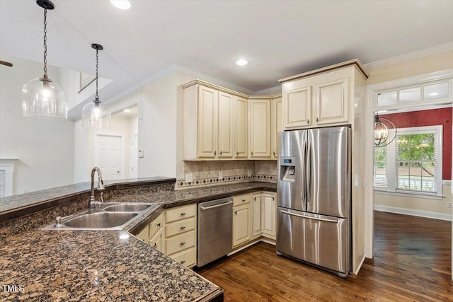 1817 Foxbrook Dr, Raleigh, NC 27603 - kitchen with appliances with stainless steel finishes, cream cabinetry, a sink, dark countertops, and ornamental molding