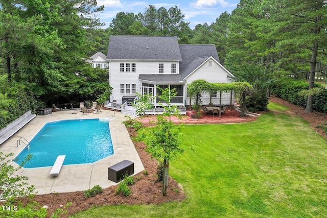 1817 Foxbrook Dr, Raleigh, NC 27603 - back of house with a yard, an outdoor pool, a patio, a deck, and a sunroom