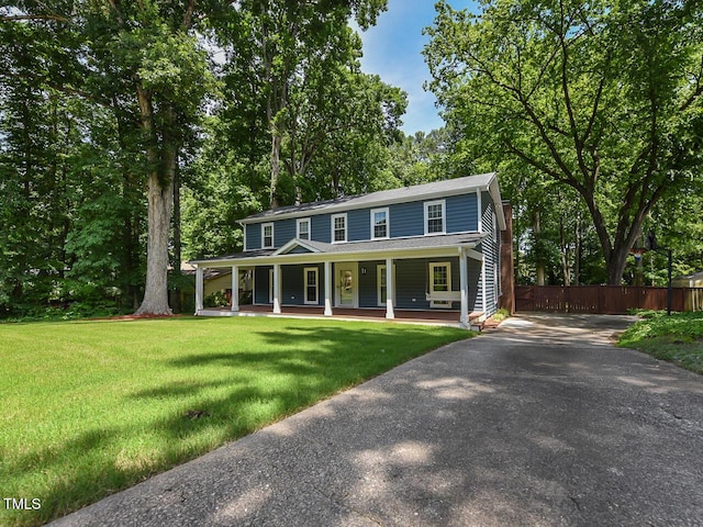 1215 Brookgreen Dr, Cary, NC 27511 - colonial home featuring a porch, asphalt driveway, and view of scattered trees