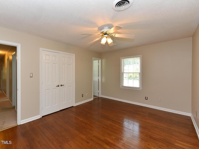 1215 Brookgreen Dr, Cary, NC 27511 - unfurnished bedroom with wood finished floors, baseboards, a closet, a textured ceiling, and a ceiling fan