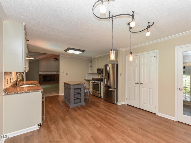 1215 Brookgreen Dr, Cary, NC 27511 - kitchen with open shelves, a sink, appliances with stainless steel finishes, a textured ceiling, and a ceiling fan