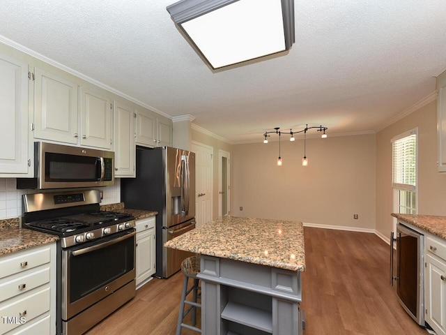 1215 Brookgreen Dr, Cary, NC 27511 - kitchen with stainless steel appliances, crown molding, wood finished floors, open shelves, and decorative backsplash