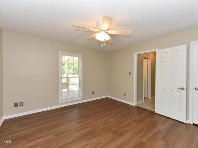 1215 Brookgreen Dr, Cary, NC 27511 - spare room featuring wood finished floors, ceiling fan, and baseboards