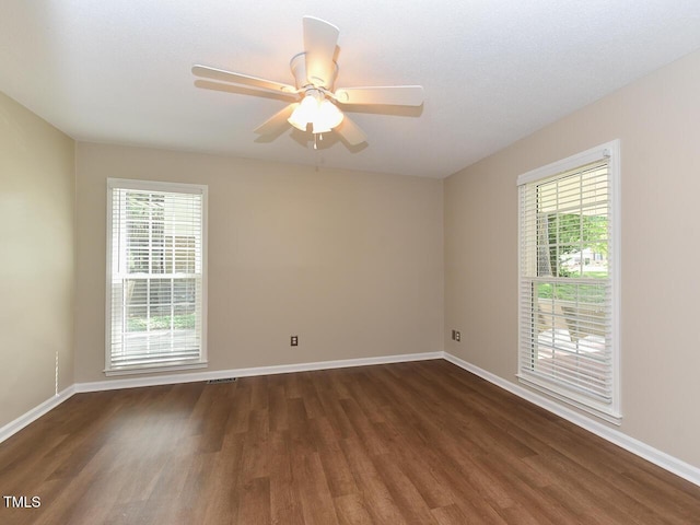 1215 Brookgreen Dr, Cary, NC 27511 - spare room with dark wood-type flooring, plenty of natural light, baseboards, and ceiling fan
