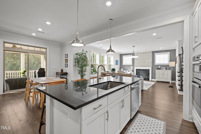 98 Stone Bridge Xing Unit 98, Chapel Hill, NC 27517 - kitchen featuring dishwasher, a sink, recessed lighting, a large fireplace, and dark wood-style flooring
