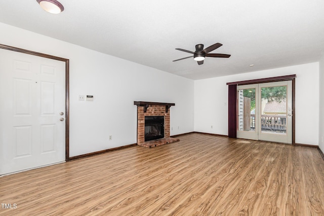 6516 Hearthstone Dr Unit 6516, Raleigh, NC 27615 - unfurnished living room with light wood finished floors, ceiling fan, baseboards, and a brick fireplace