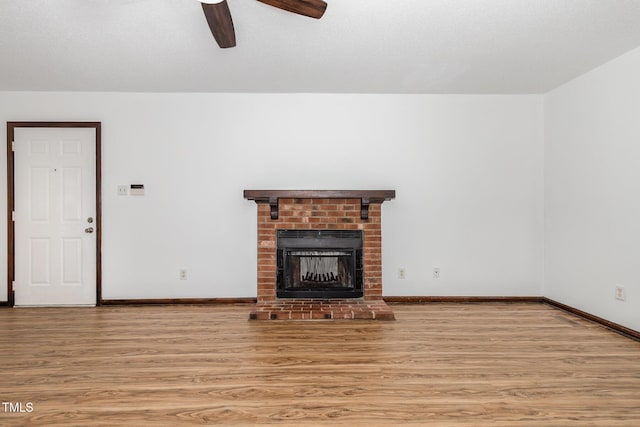 6516 Hearthstone Dr Unit 6516, Raleigh, NC 27615 - unfurnished living room with light wood finished floors, ceiling fan, baseboards, and a fireplace