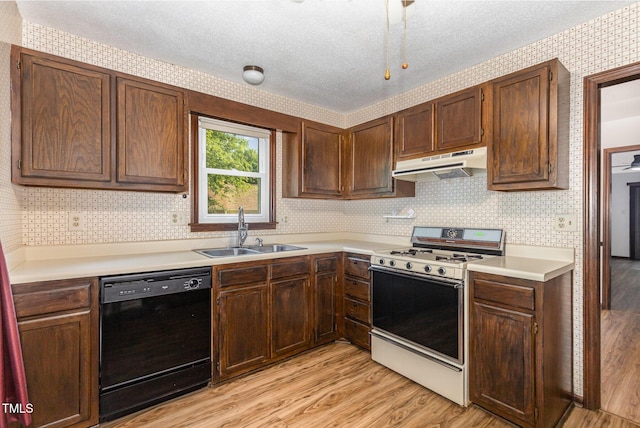 6516 Hearthstone Dr Unit 6516, Raleigh, NC 27615 - kitchen with black dishwasher, a sink, gas range, under cabinet range hood, and light wood-type flooring