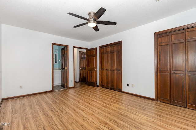 6516 Hearthstone Dr Unit 6516, Raleigh, NC 27615 - unfurnished bedroom featuring light wood finished floors, baseboards, and multiple closets