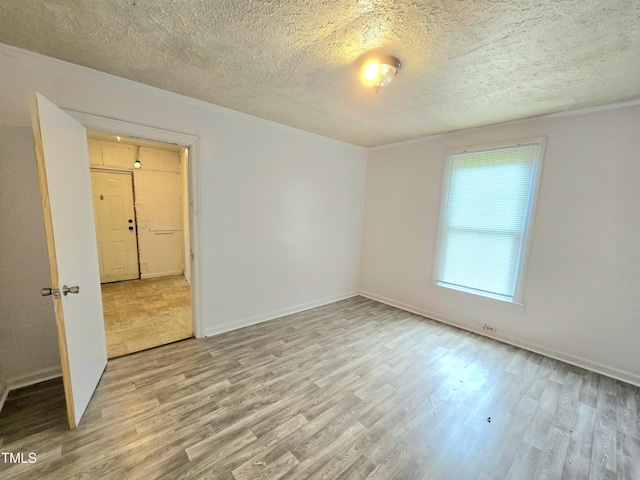 1109 N George St, Goldsboro, NC 27530 - empty room with wood finished floors, a textured ceiling, and baseboards