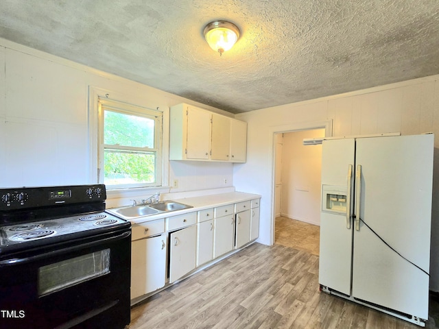 1109 N George St, Goldsboro, NC 27530 - kitchen featuring white refrigerator with ice dispenser, black / electric stove, a sink, light wood finished floors, and light countertops