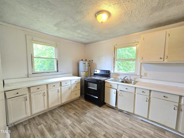 1109 N George St, Goldsboro, NC 27530 - kitchen featuring black electric range, light wood finished floors, electric water heater, light countertops, and a textured ceiling