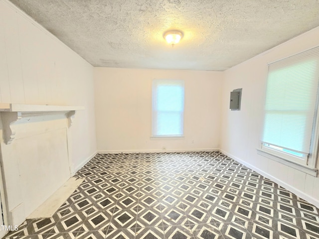 1109 N George St, Goldsboro, NC 27530 - unfurnished dining area featuring tile patterned floors, a textured ceiling, electric panel, and baseboards