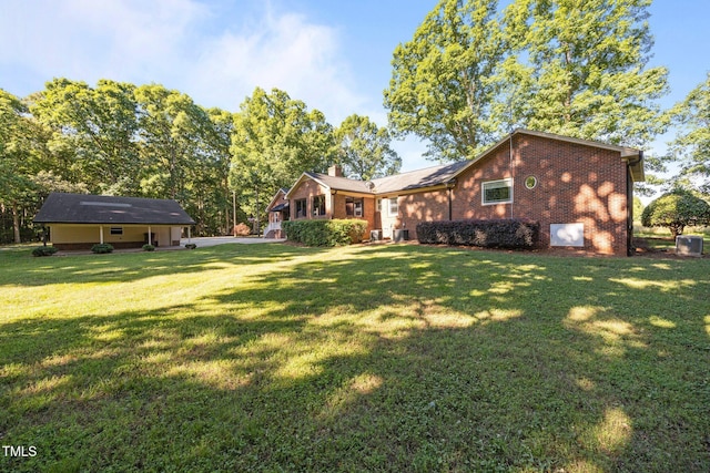 1973 Elon Ossipee Rd, Elon, NC 27244 - rear view of house with brick siding, a yard, and a chimney