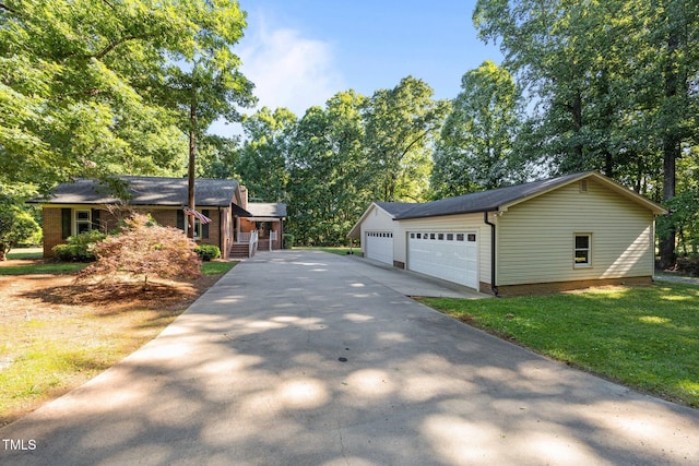 1973 Elon Ossipee Rd, Elon, NC 27244 - view of front of home with driveway, a front lawn, an outdoor structure, and a garage