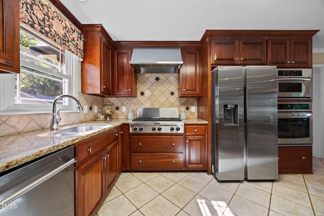 1973 Elon Ossipee Rd, Elon, NC 27244 - kitchen featuring stainless steel appliances, wall chimney exhaust hood, a sink, light stone counters, and tasteful backsplash