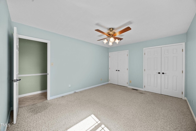 1973 Elon Ossipee Rd, Elon, NC 27244 - unfurnished bedroom with multiple closets, carpet floors, baseboards, and a ceiling fan