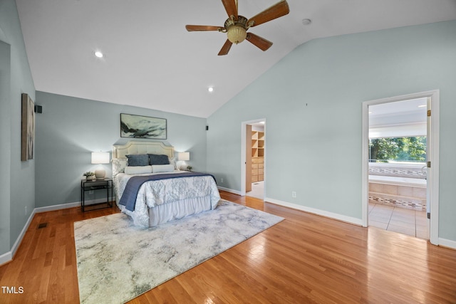 1973 Elon Ossipee Rd, Elon, NC 27244 - bedroom with wood finished floors, high vaulted ceiling, baseboards, and connected bathroom