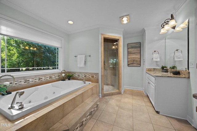 1973 Elon Ossipee Rd, Elon, NC 27244 - bathroom featuring vanity, a jetted tub, a shower stall, tile patterned floors, and crown molding