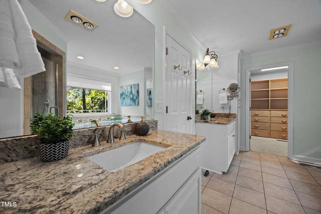 1973 Elon Ossipee Rd, Elon, NC 27244 - full bath featuring two vanities, ornamental molding, tile patterned floors, a spacious closet, and an enclosed shower