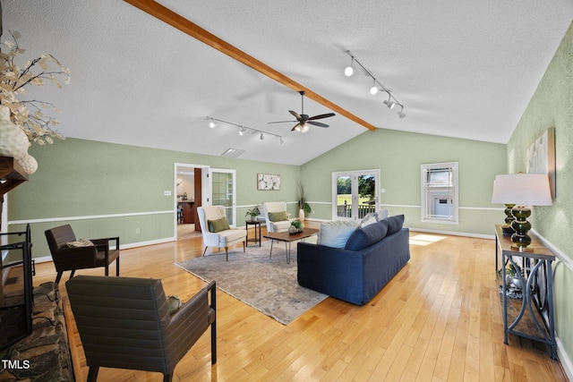 1973 Elon Ossipee Rd, Elon, NC 27244 - living area featuring lofted ceiling, track lighting, ceiling fan, a textured ceiling, and wood-type flooring