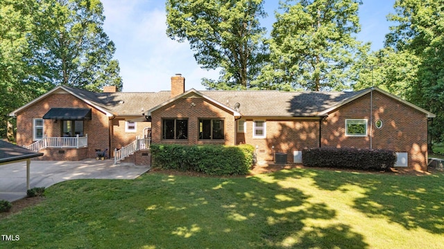 1973 Elon Ossipee Rd, Elon, NC 27244 - rear view of house with brick siding, a lawn, a chimney, and crawl space