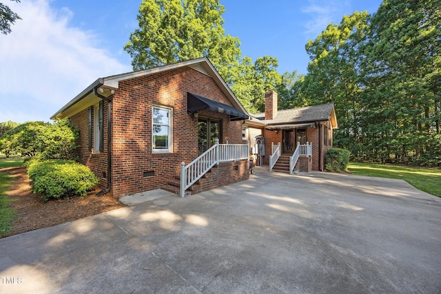 1973 Elon Ossipee Rd, Elon, NC 27244 - view of front of property featuring brick siding, crawl space, a chimney, driveway, and a porch