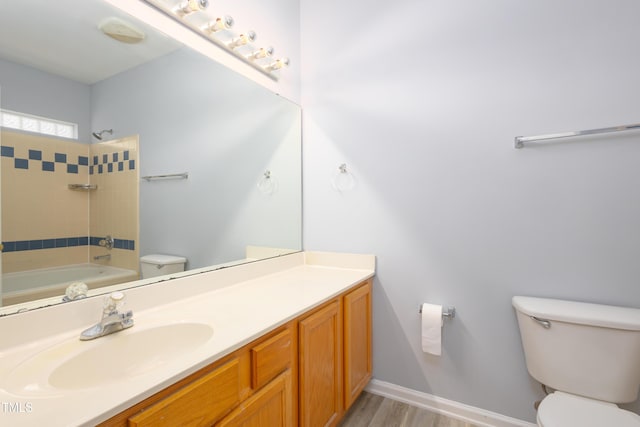 1510 Bungalow Ave, Durham, NC 27703 - full bathroom with toilet, vanity,  shower combination, and wood finished floors