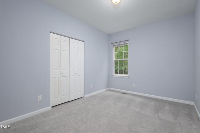 1510 Bungalow Ave, Durham, NC 27703 - unfurnished bedroom featuring carpet floors, baseboards, and a closet