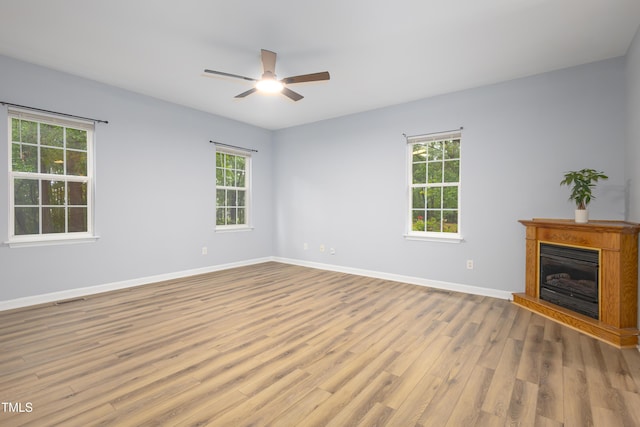 1510 Bungalow Ave, Durham, NC 27703 - empty room featuring wood finished floors, healthy amount of natural light, a ceiling fan, and baseboards