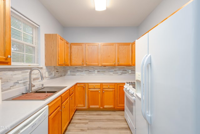 1510 Bungalow Ave, Durham, NC 27703 - kitchen featuring white appliances, light wood-style floors, backsplash, and a sink