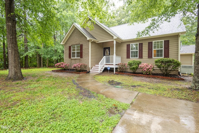 1510 Bungalow Ave, Durham, NC 27703 - ranch-style home with a front lawn, cooling unit, and roof with shingles