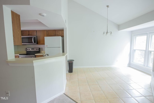 115 Abingdon Ct Unit 2B, Cary, NC 27513 - kitchen with appliances with stainless steel finishes, light countertops, brown cabinetry, a peninsula, and light tile patterned flooring