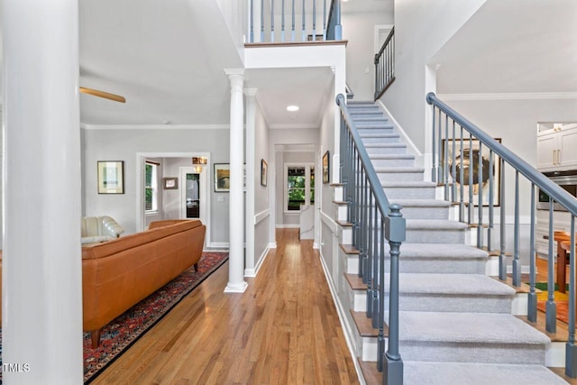 4408 Queenstown Ct, Raleigh, NC 27612 - entryway featuring wood finished floors, stairway, ornamental molding, baseboards, and decorative columns
