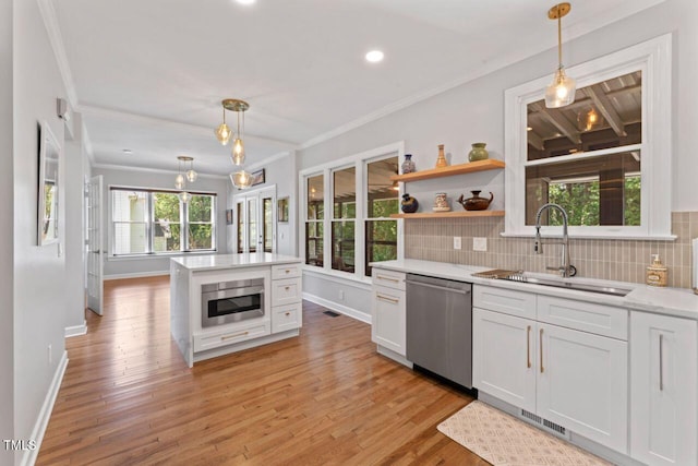 4408 Queenstown Ct, Raleigh, NC 27612 - kitchen featuring appliances with stainless steel finishes, a sink, crown molding, light countertops, and baseboards