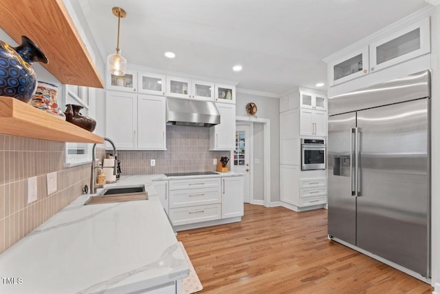 4408 Queenstown Ct, Raleigh, NC 27612 - kitchen with appliances with stainless steel finishes, under cabinet range hood, open shelves, backsplash, and white cabinetry