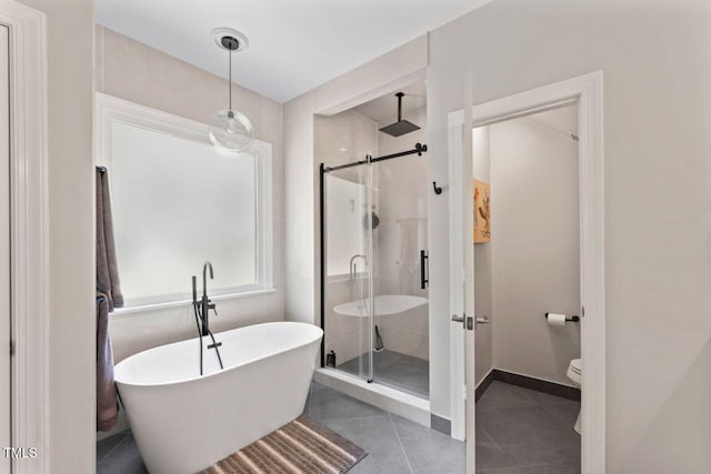 4408 Queenstown Ct, Raleigh, NC 27612 - bathroom with a stall shower, a freestanding bath, toilet, tile patterned flooring, and baseboards