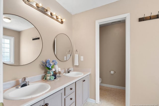122 Van Buren Dr, Raeford, NC 28376 - full bathroom with double vanity, toilet, and baseboards