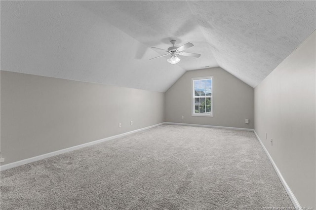 4404 Bunkers Bay Ln, Parkton, NC 28371 - additional living space featuring carpet, lofted ceiling, baseboards, ceiling fan, and a textured ceiling