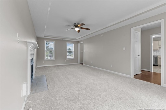 4404 Bunkers Bay Ln, Parkton, NC 28371 - unfurnished living room with a ceiling fan, carpet floors, a raised ceiling, baseboards, and a fireplace with flush hearth