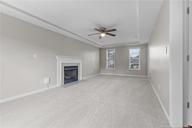 4404 Bunkers Bay Ln, Parkton, NC 28371 - unfurnished living room with a raised ceiling, a ceiling fan, light colored carpet, and a tile fireplace